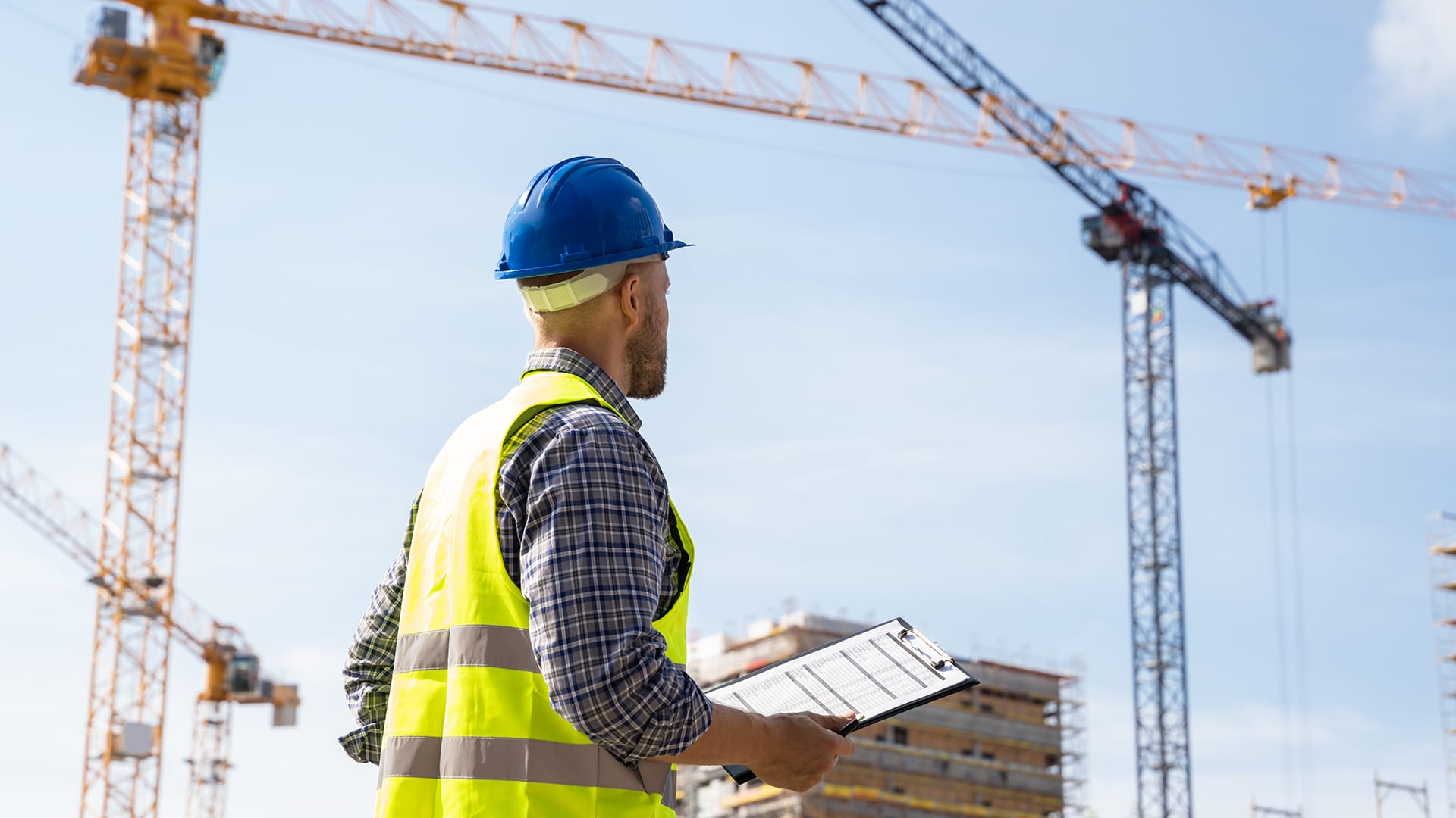 Man checking safety at construction site using outriggers and outrigger pads