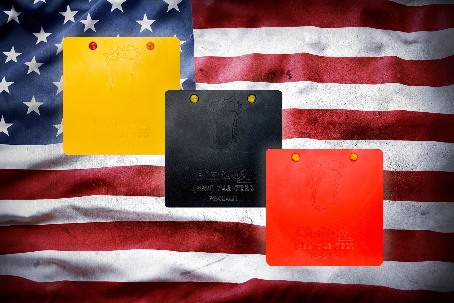 Bigfoot Outrigger Pads in yellow, black and orange in front of American Flag - Made in the U.S.A.