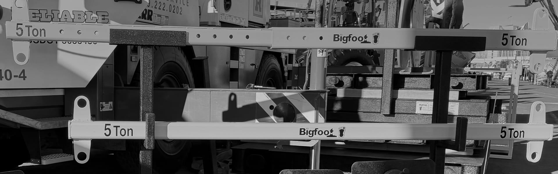 Steel spreader bars from Bigfoot Outrigger Pads in grayscale